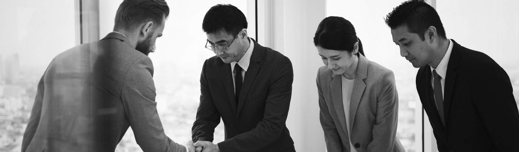 Japanese business people having a handshake with a colleague